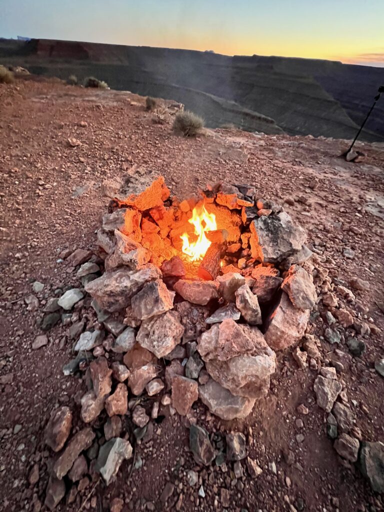 Camp fire next to the edge of a cliff at Goosenecks State Park.