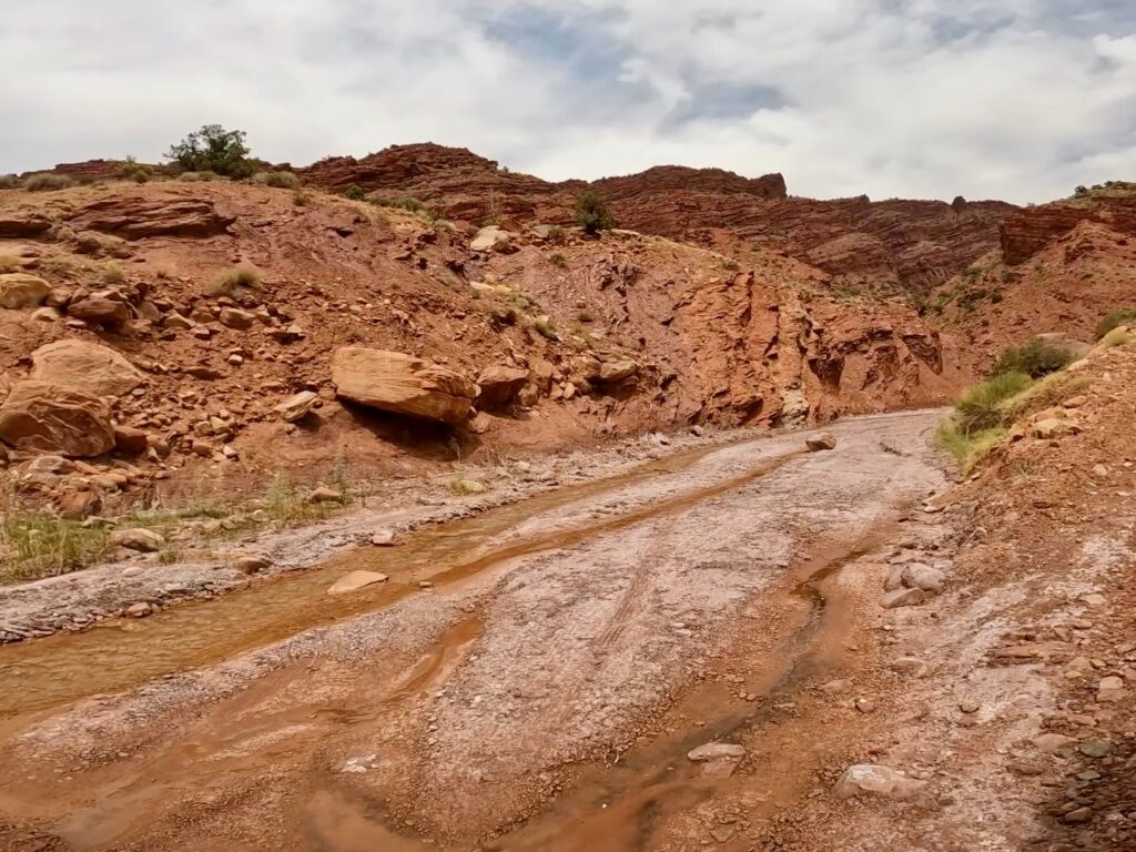 Dry sulfur-stained creek bed.