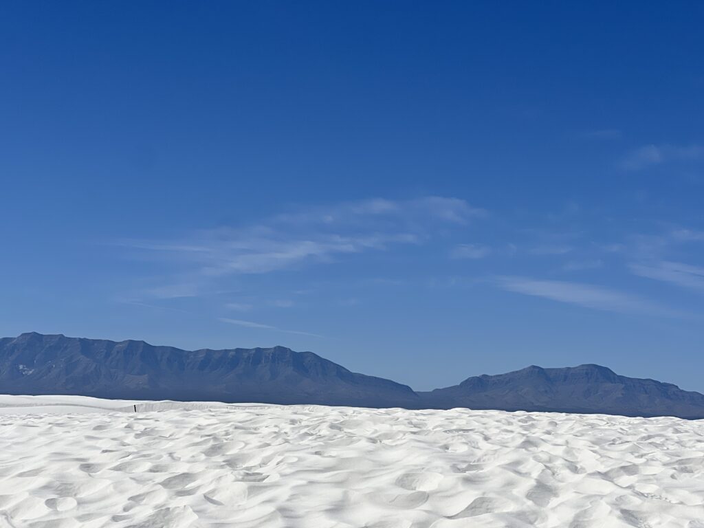 White gypsum dunes with mountain backdrop at White Sands National Park